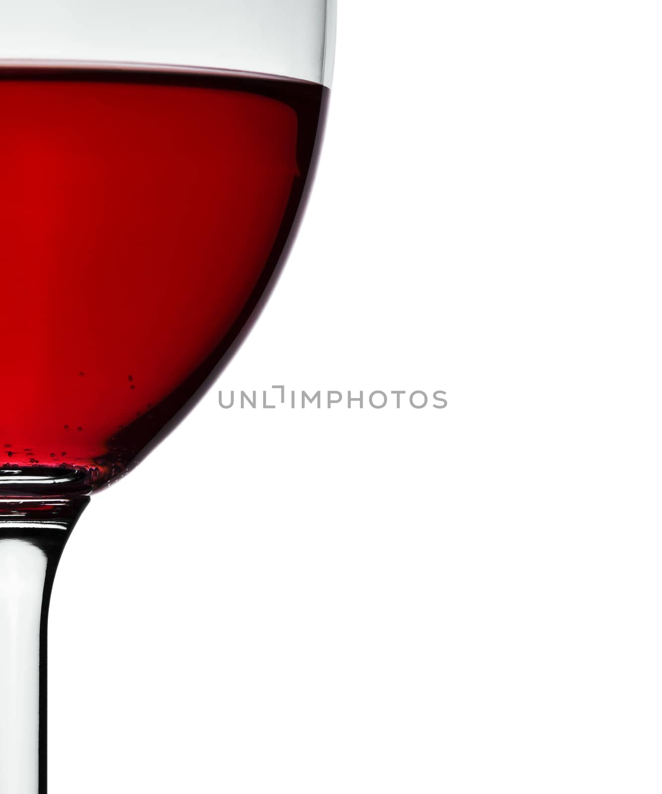 crop of wineglass with red wine by mihalec