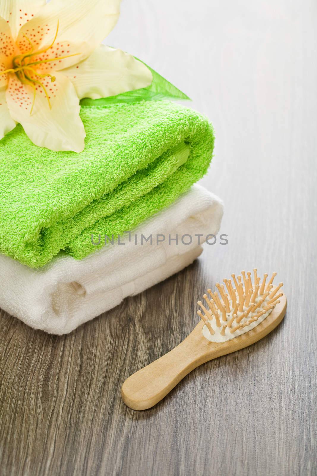 flower on cotton towels with hairbrush by mihalec