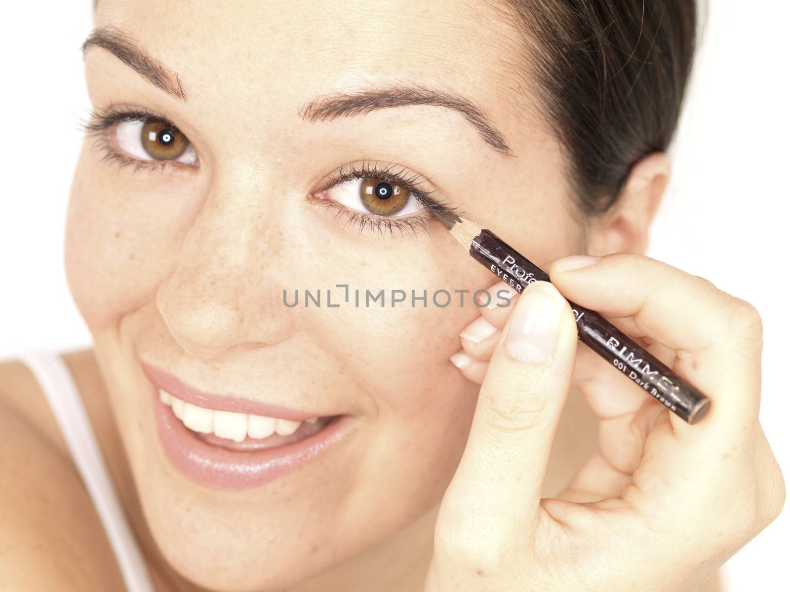 Young Woman Applying Eyeliner. Model Released