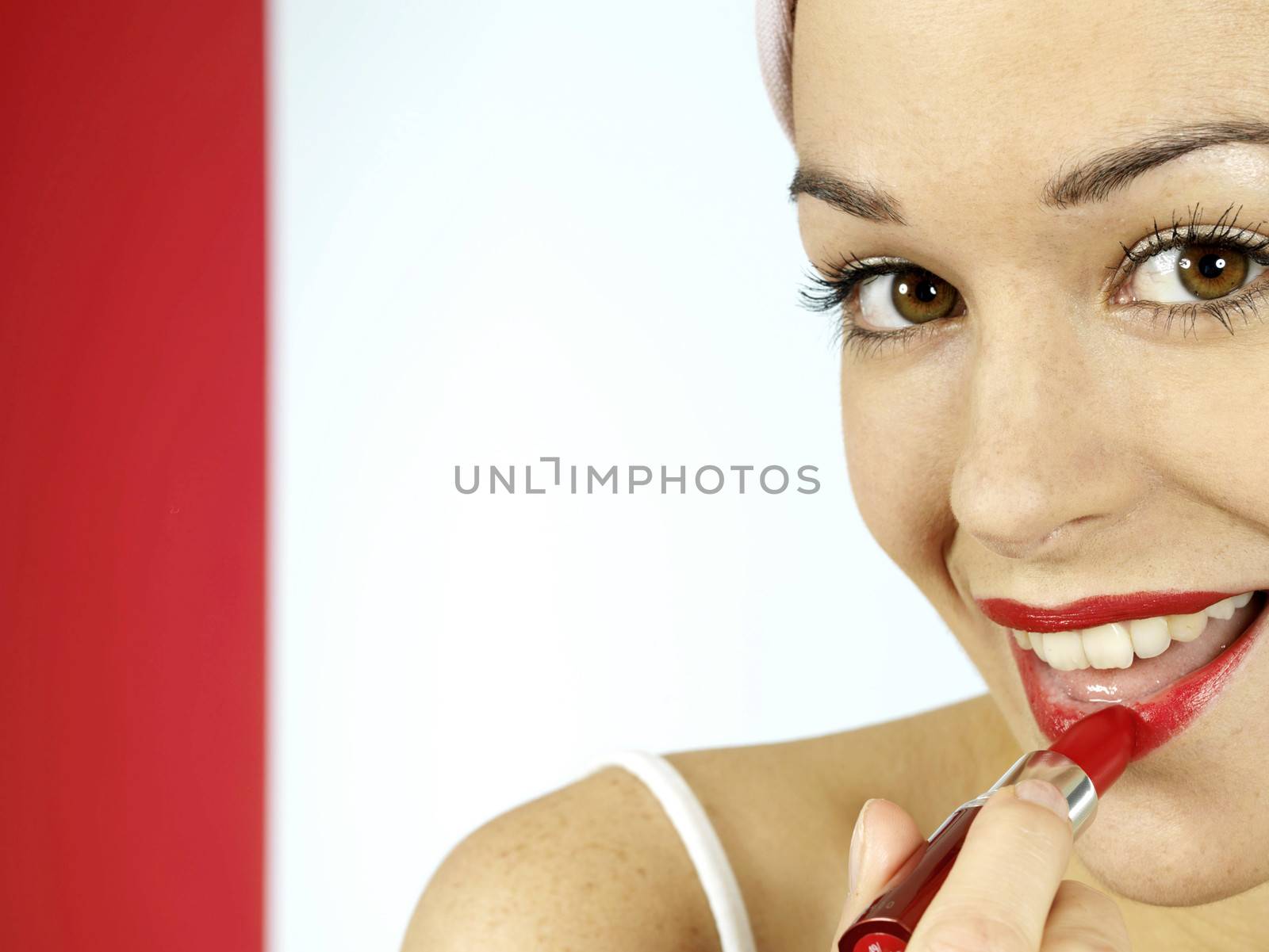 Young Woman Applying Red Lipstick. Model Released
