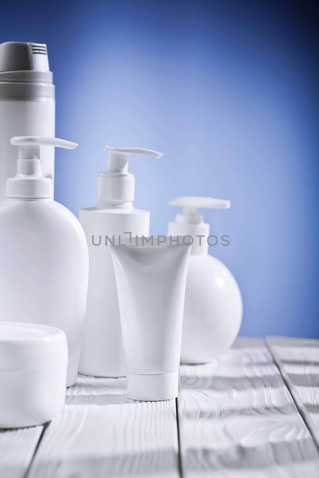 skincare composition on a blue background and white table