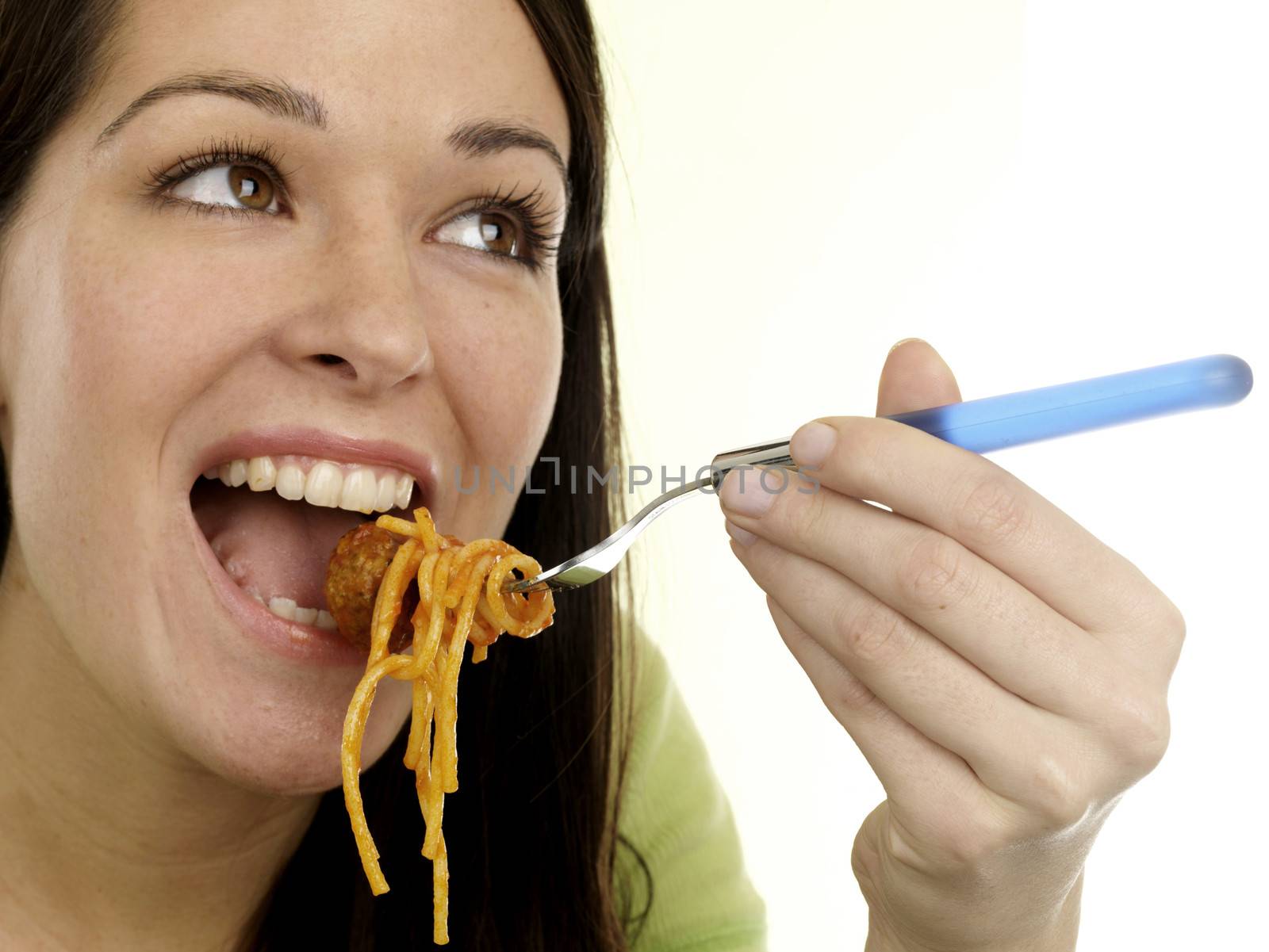 Young Woman Eating Spaghetti and Meatballs. Model Released