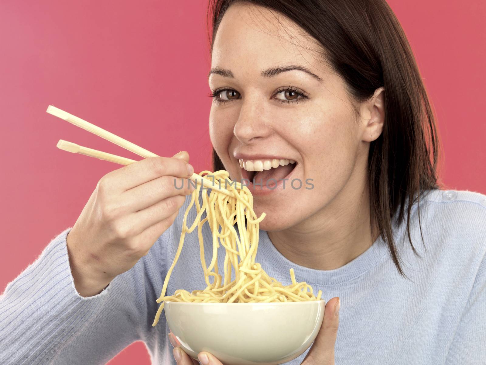 Young Woman Eating Noodles. Model Released