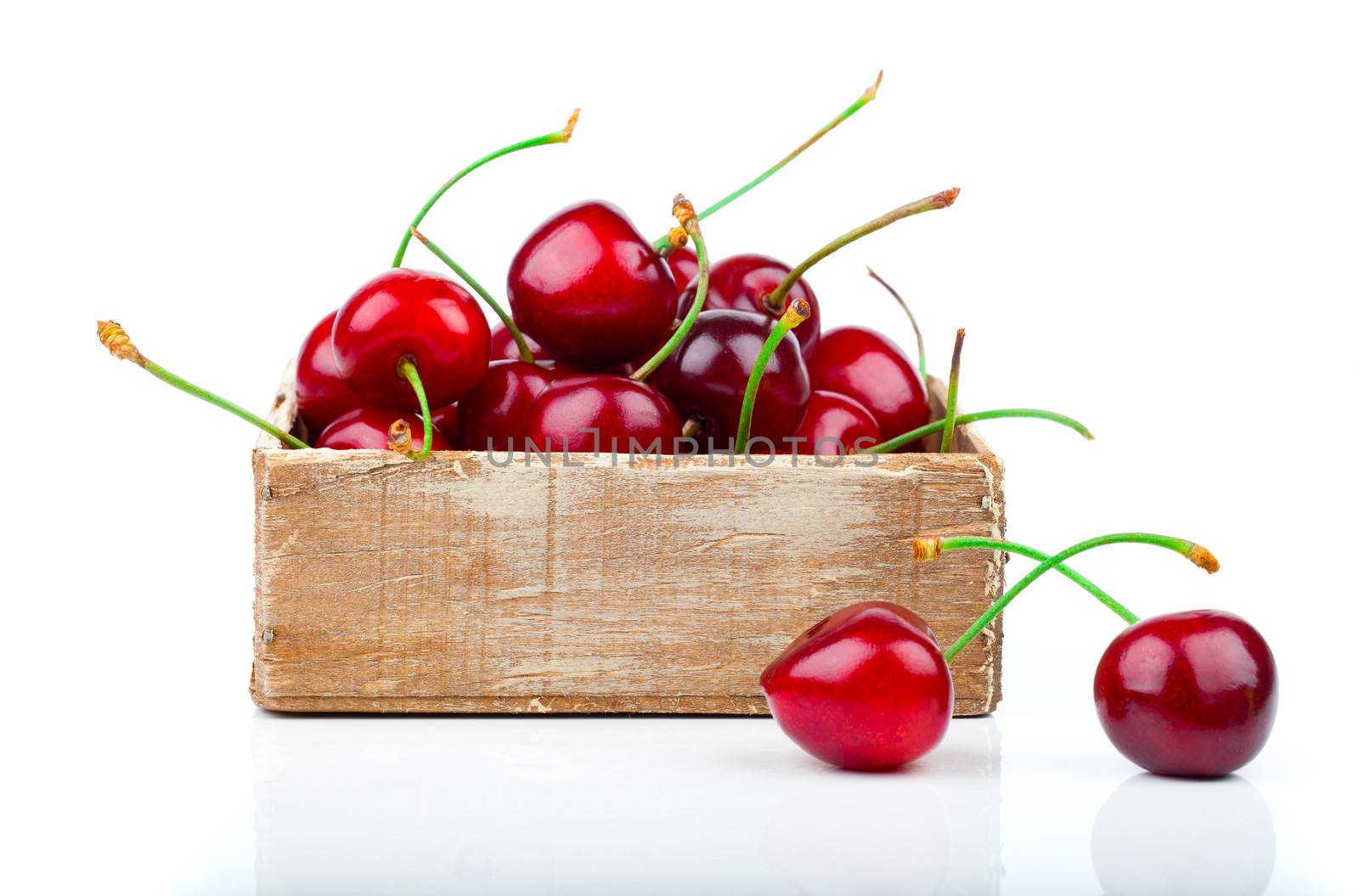 cherry berry in wooden bowl, isolated on white background