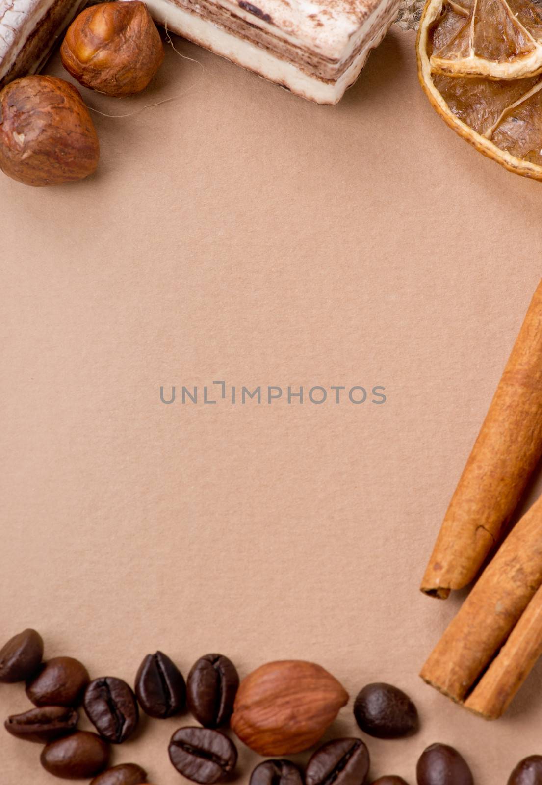 Close up of coffee, cinnamon, nuts, sweet on old paper material. Place for text.