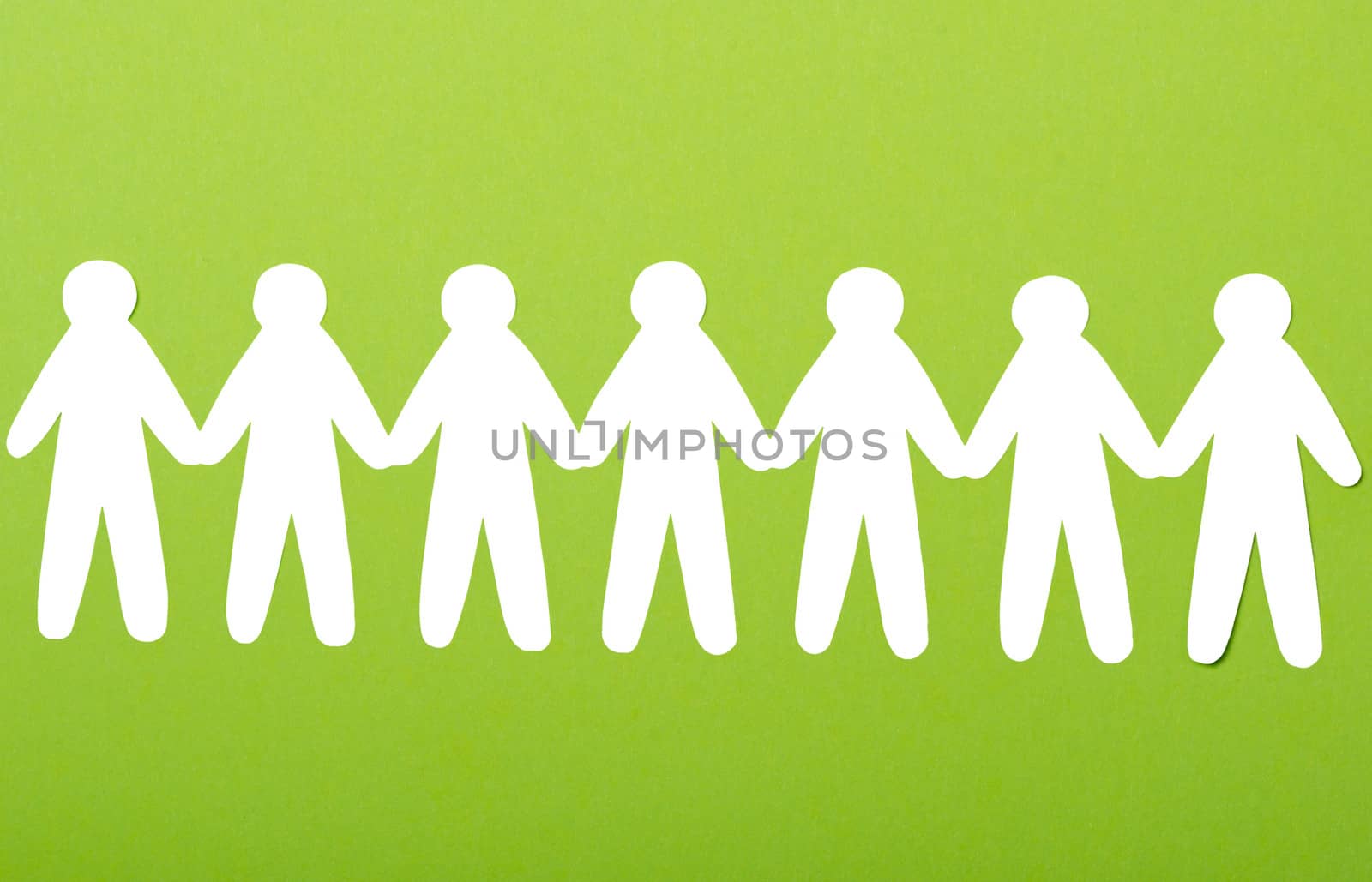 team of paper people on green background