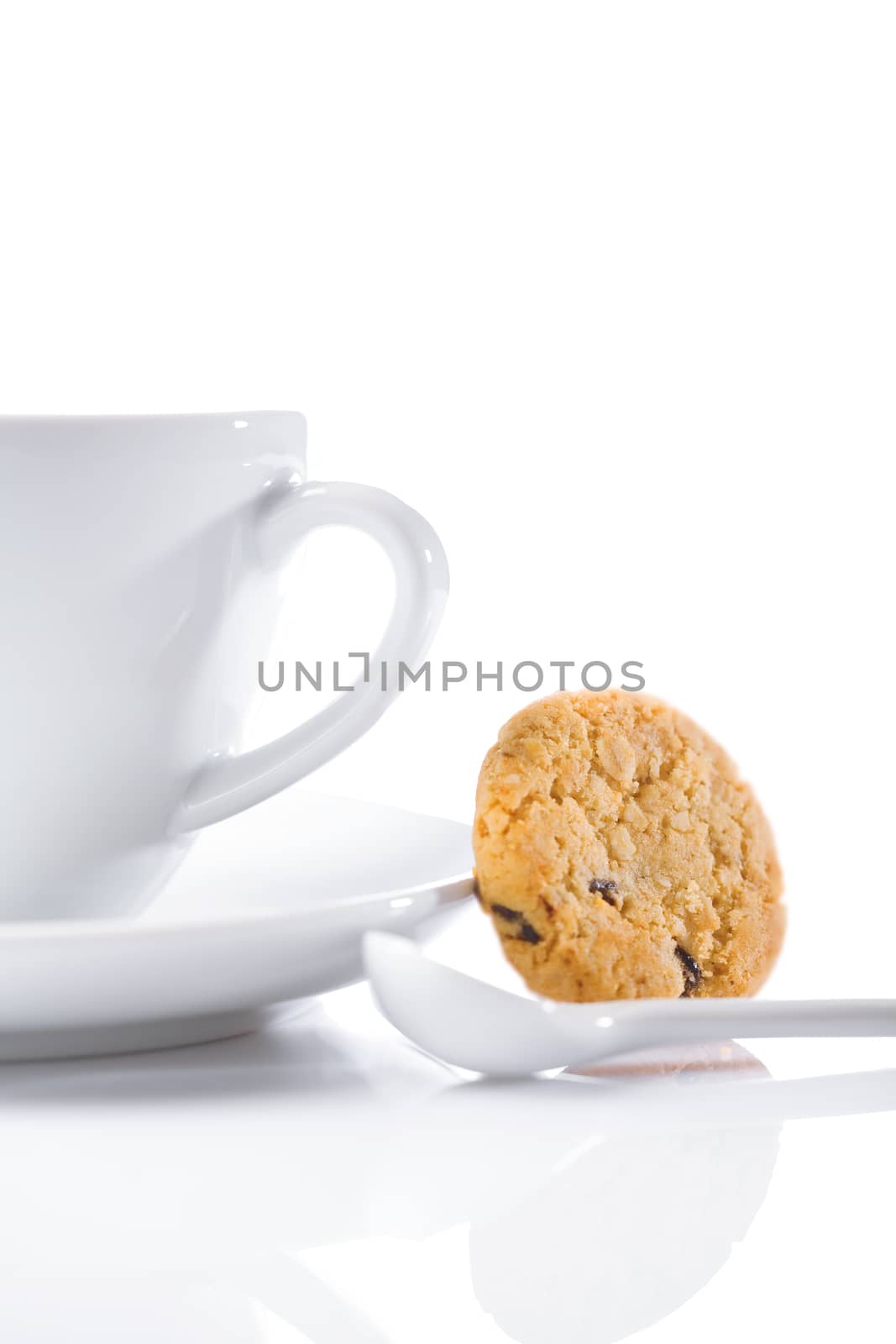 cup and spoon with cookie isolated