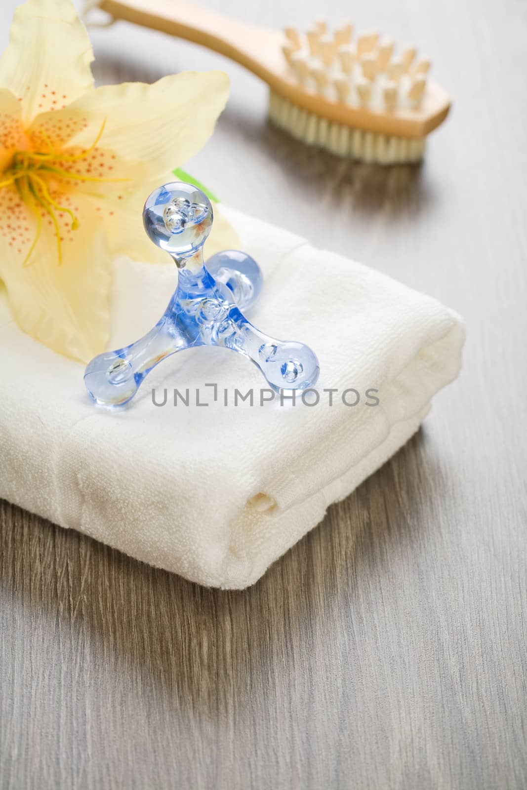 flower and massager on white towel with massager