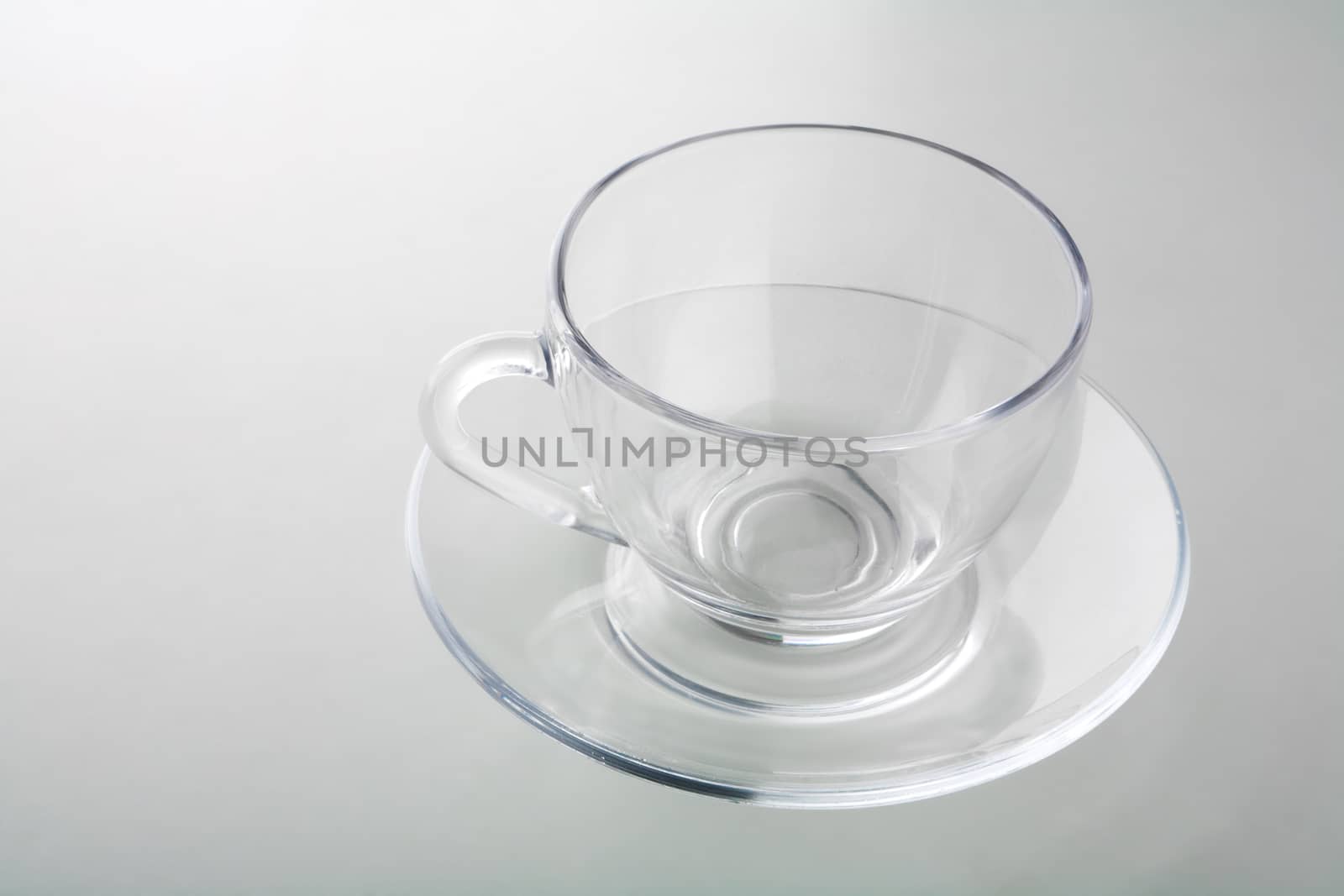 cup on plate isolated on gray