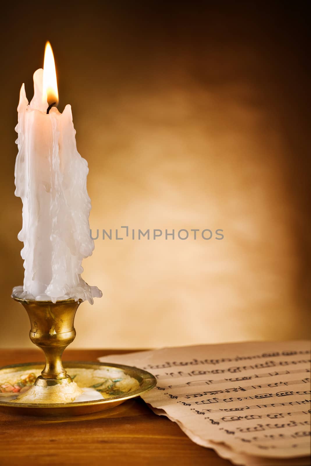 copy space view on the ablaze candle and old notes