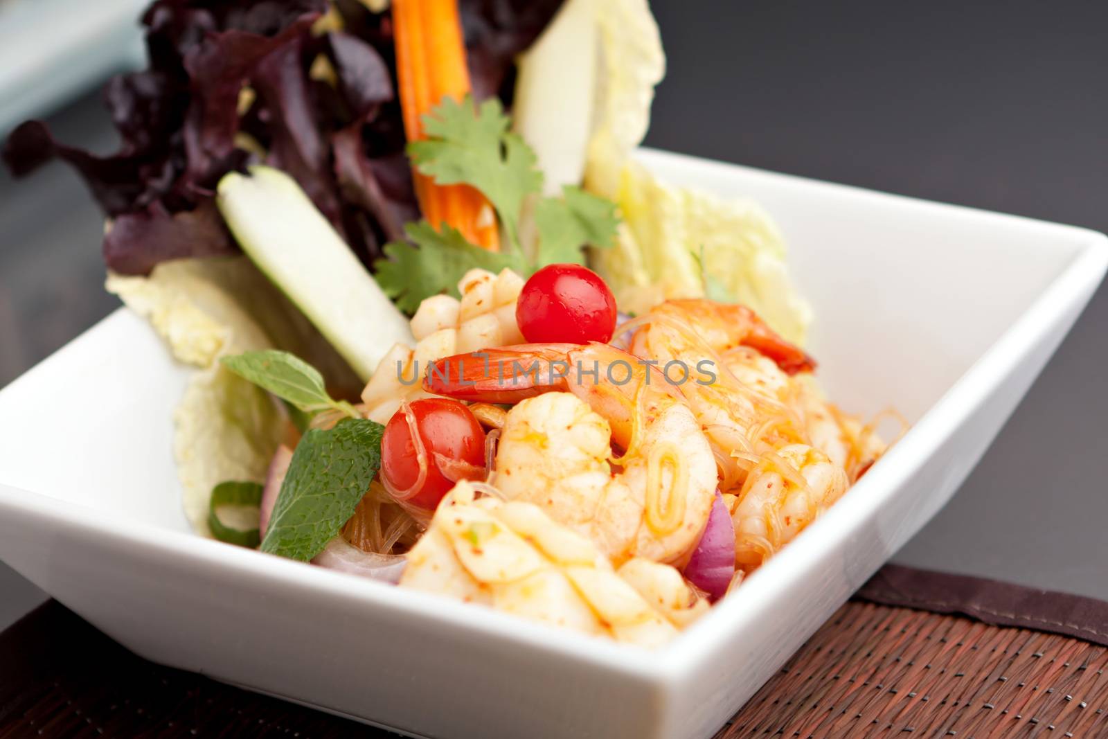 Thailand style seafood salad with clear vermicelli style rice noodles and veggies.