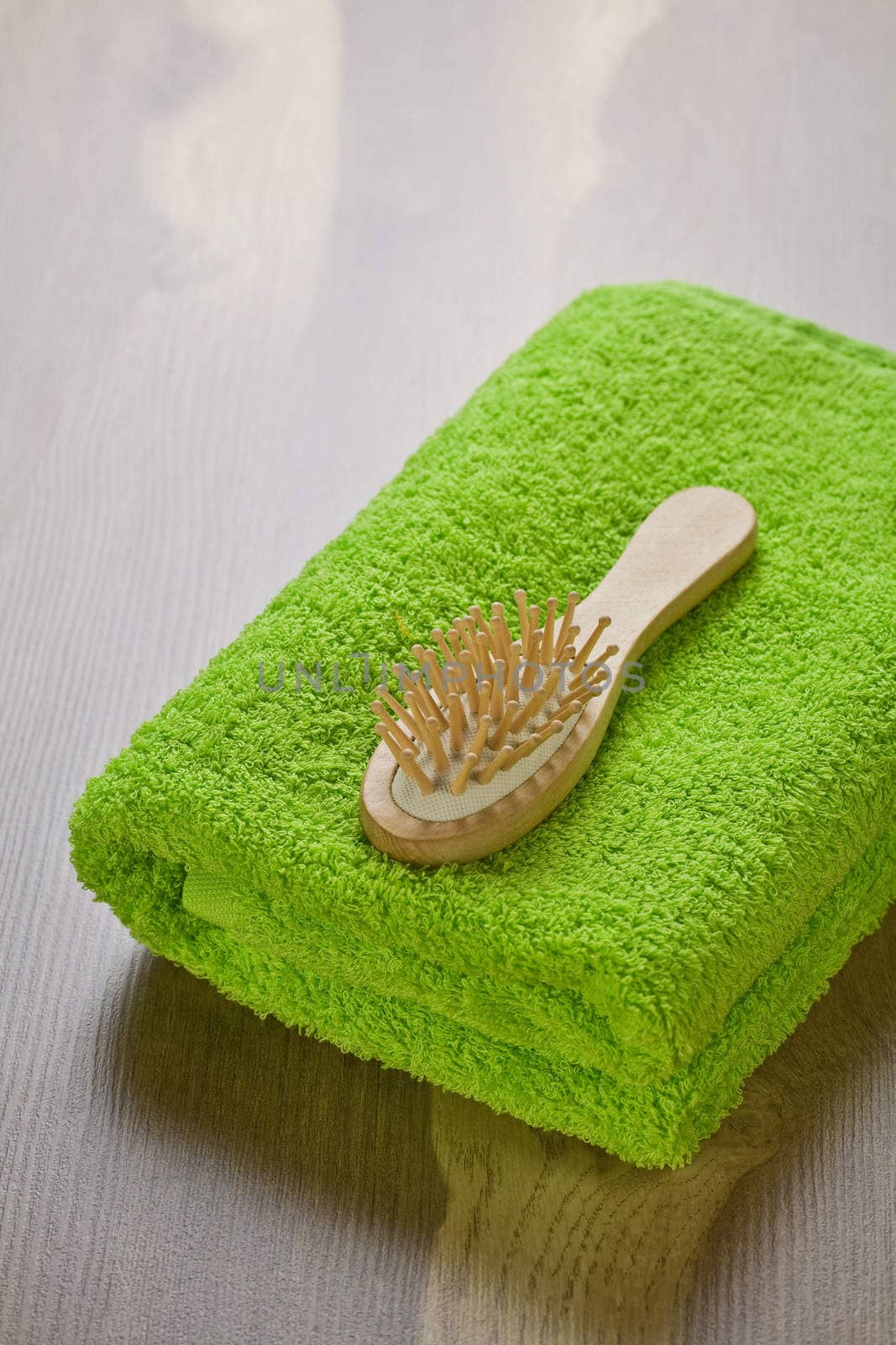 green towel with hairbrush