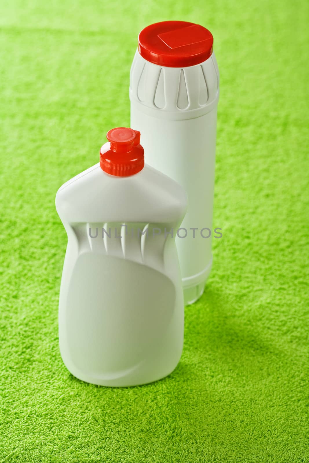 two bottles on green background