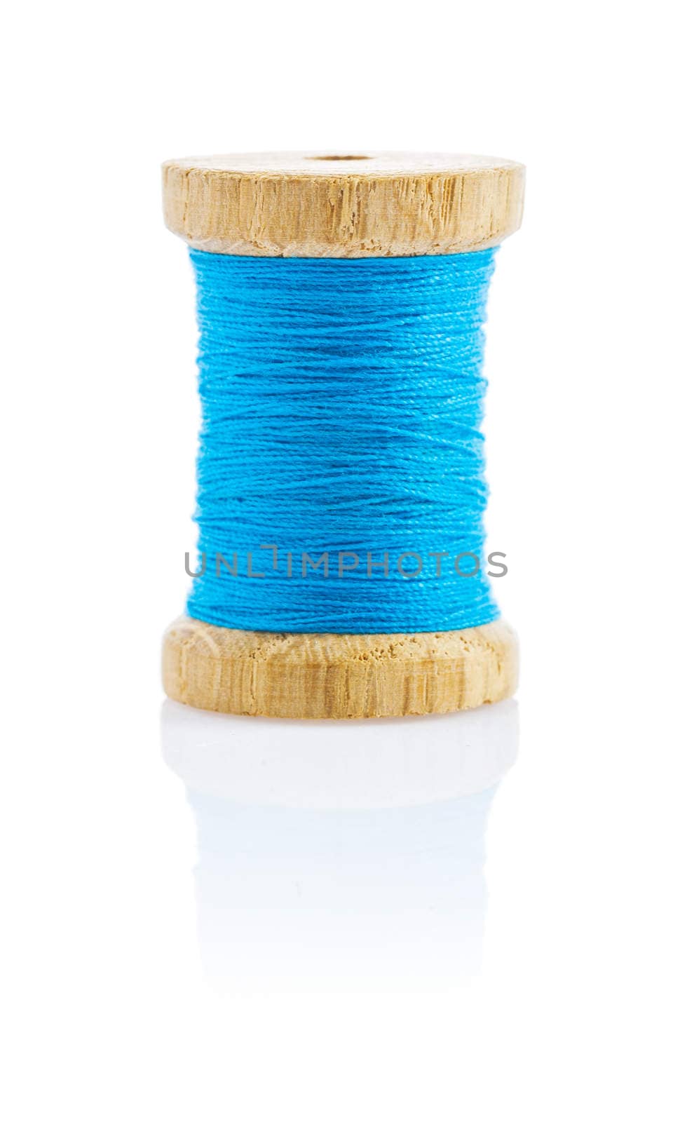 a small wooden bobbin with blue thread