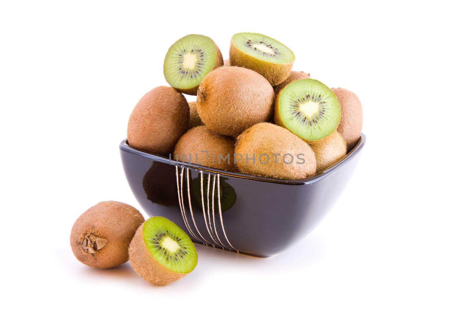 Kiwi fruits in a black bowl isolated on white background