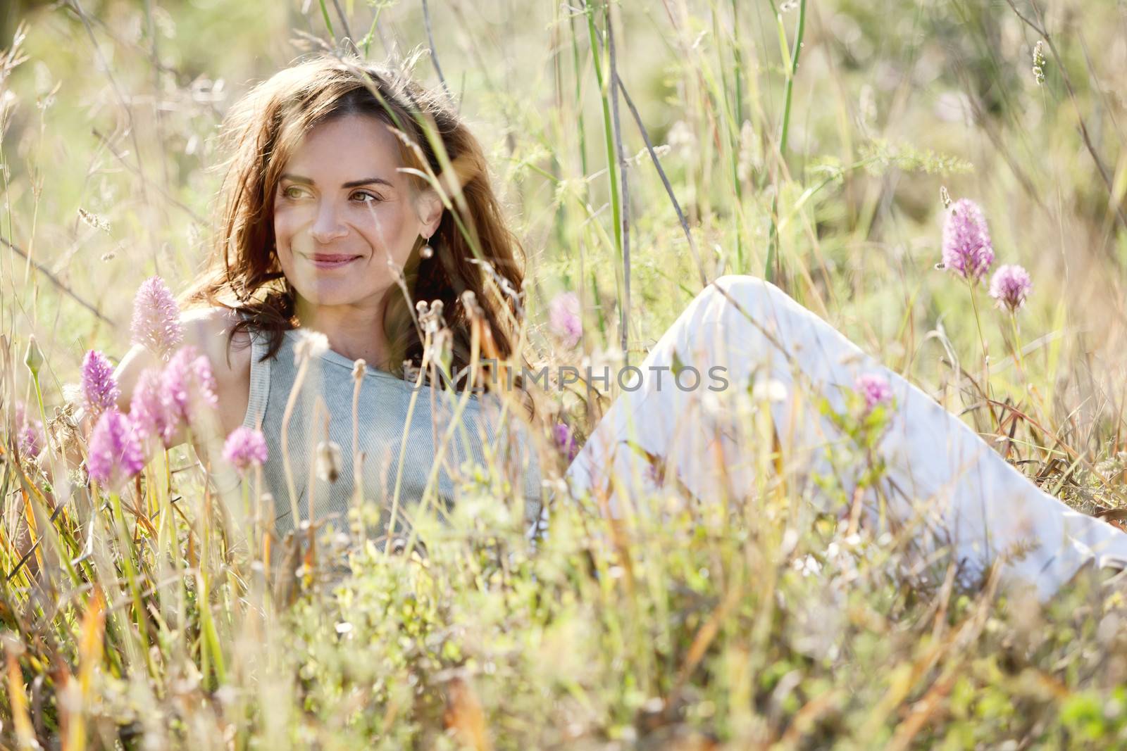 adult brunette woman smiling in summertime outdoor nature
