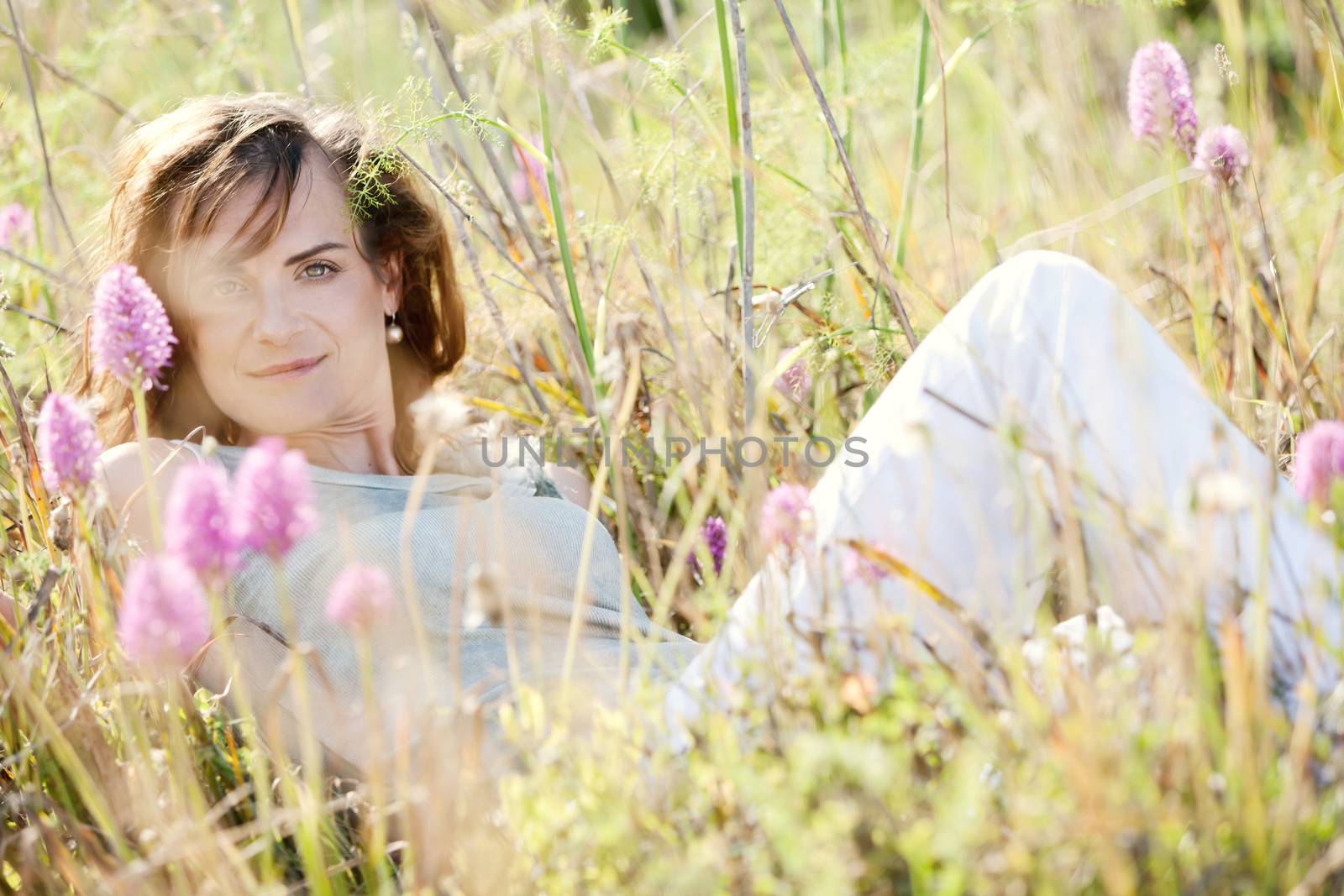 adult brunette woman smiling in summertime outdoor nature