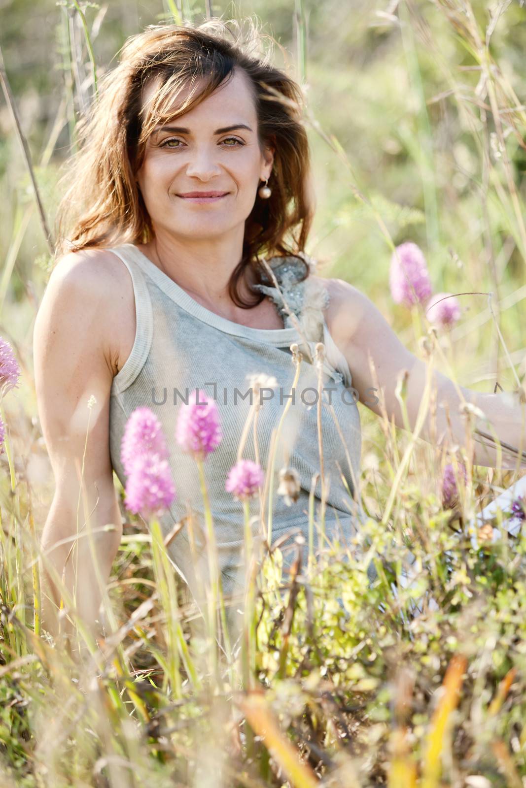 adult brunette woman smiling in summertime outdoor nature