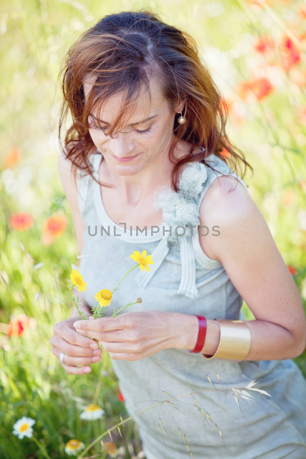 adult brunette woman smiling in summertime outdoor nature
