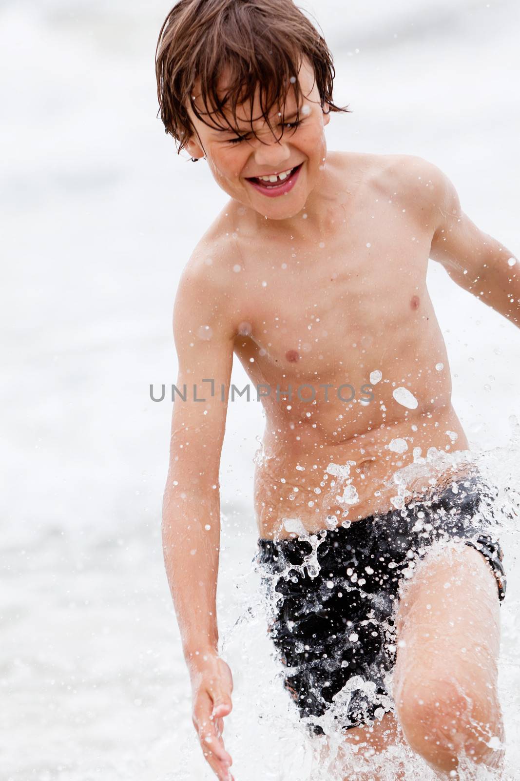 young little boy in water summer holiday having fun sea ocean 