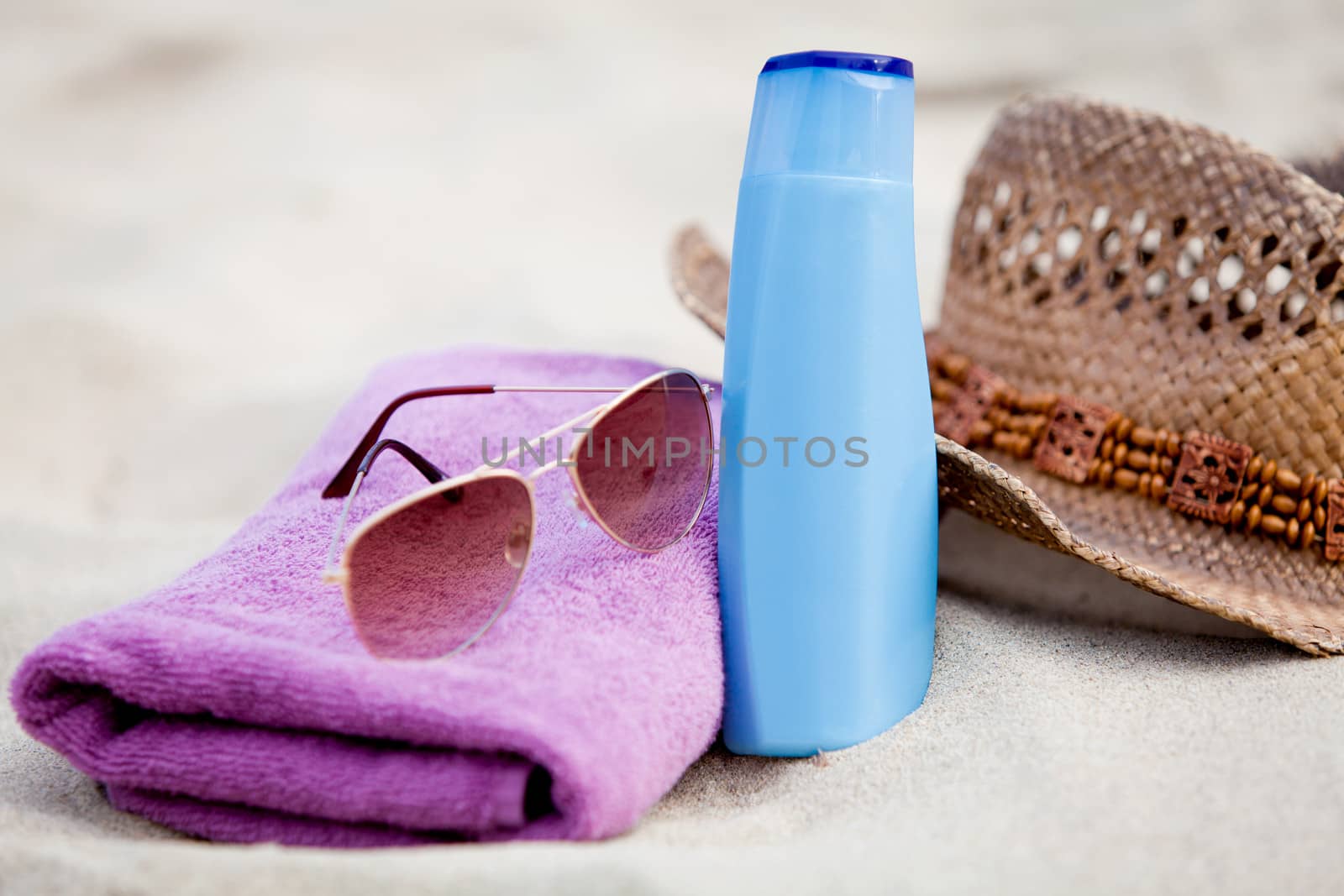 sunprotection objects on the beach in holiday sunglasses hat suncare