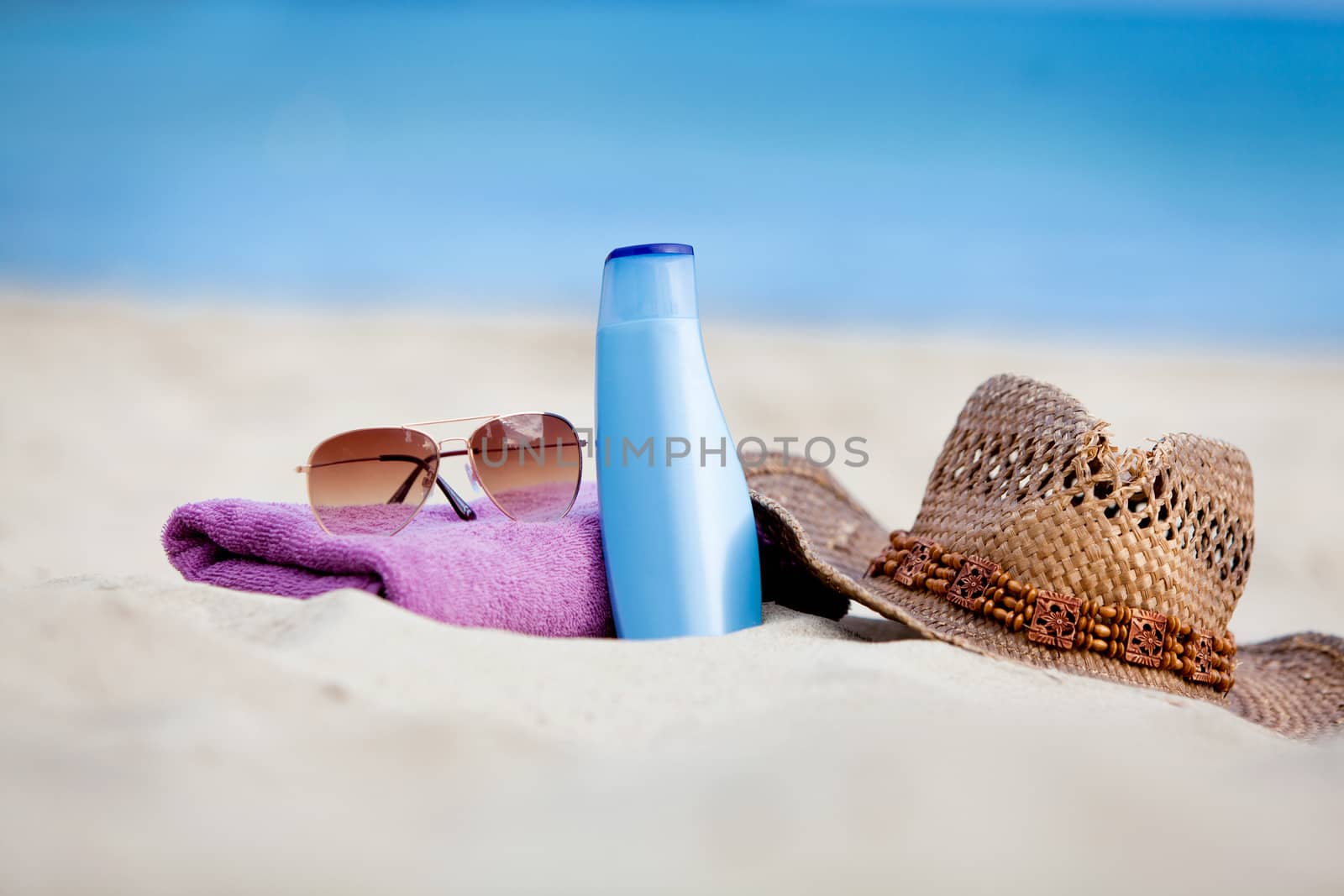 sunprotection objects on the beach in holiday sunglasses hat suncare