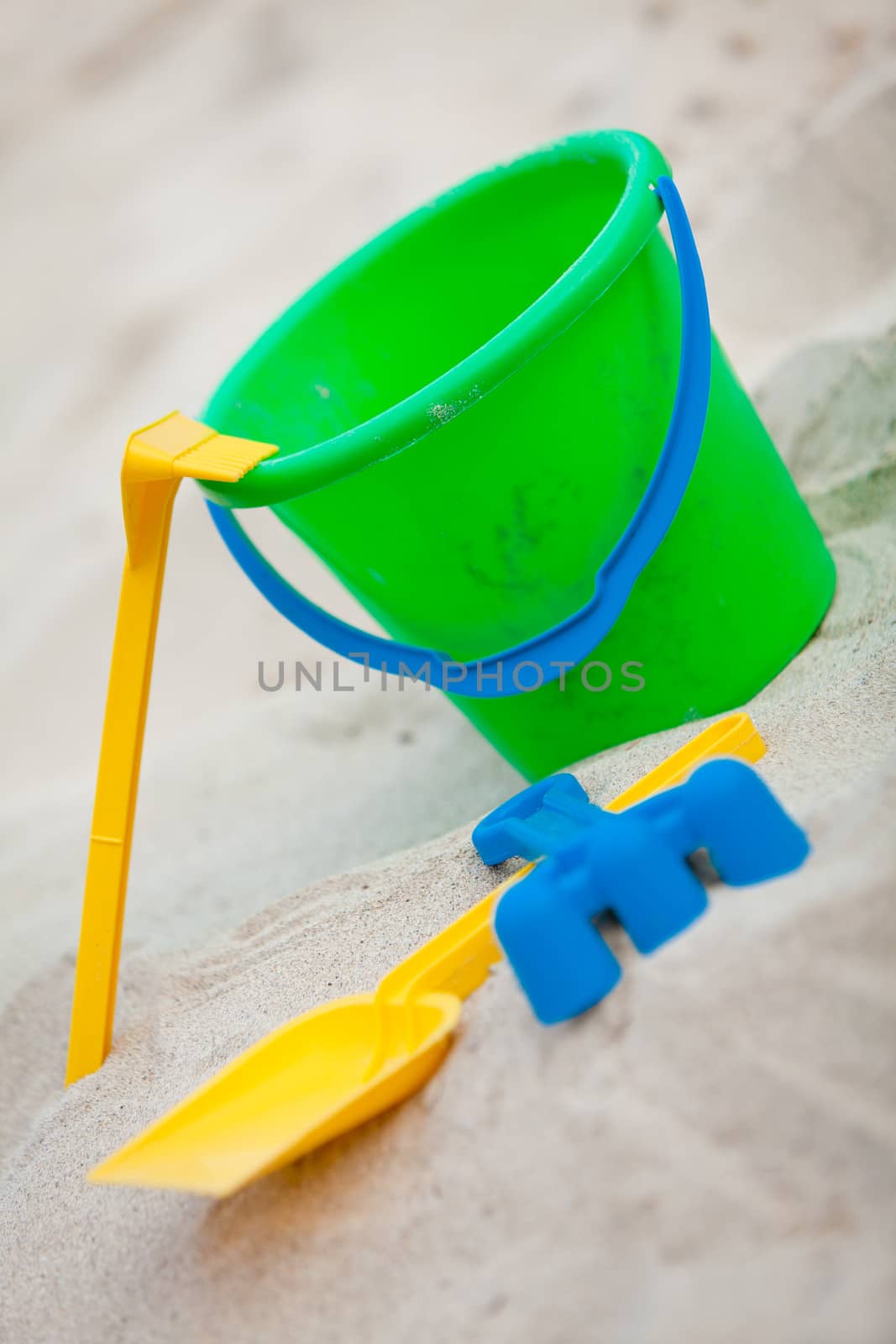 plastik colorful toys in sand on beach in summer holiday vacation