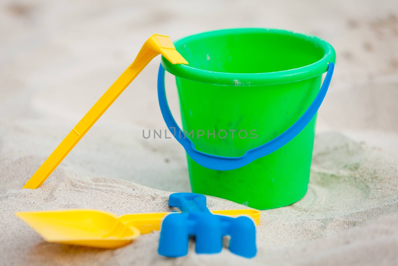 plastik colorful toys in sand on beach in summer holiday vacation