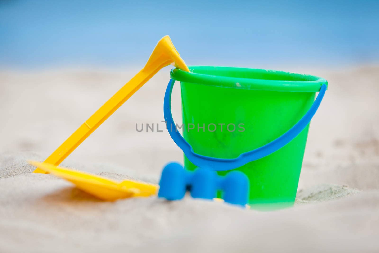 plastik colorful toys in sand on beach in summer holiday vacation