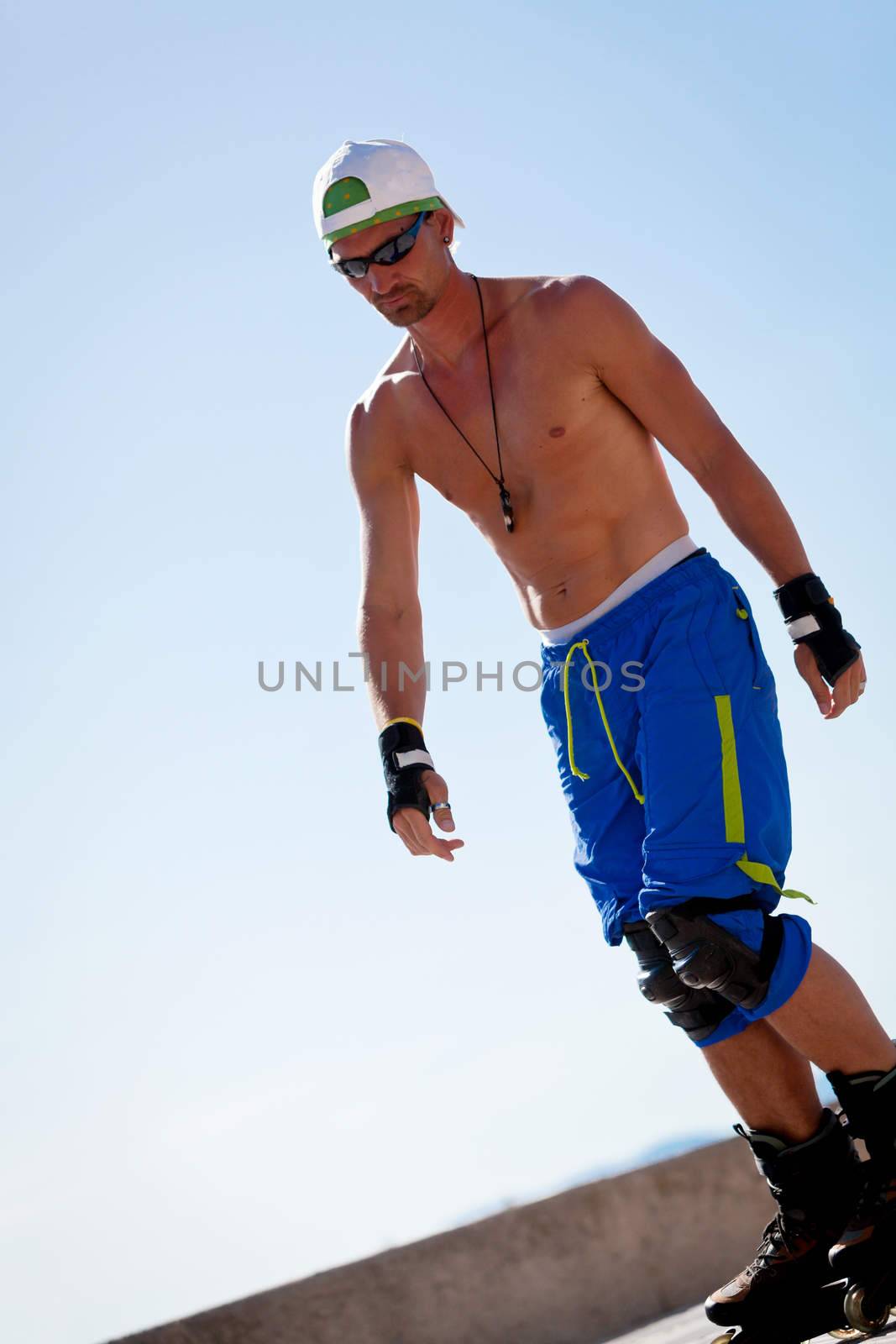 young man with inline skates in summer outdoor rollerblades skater