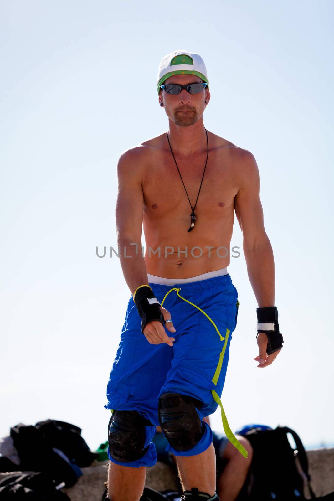 young man with inline skates in summer outdoor rollerblades skater