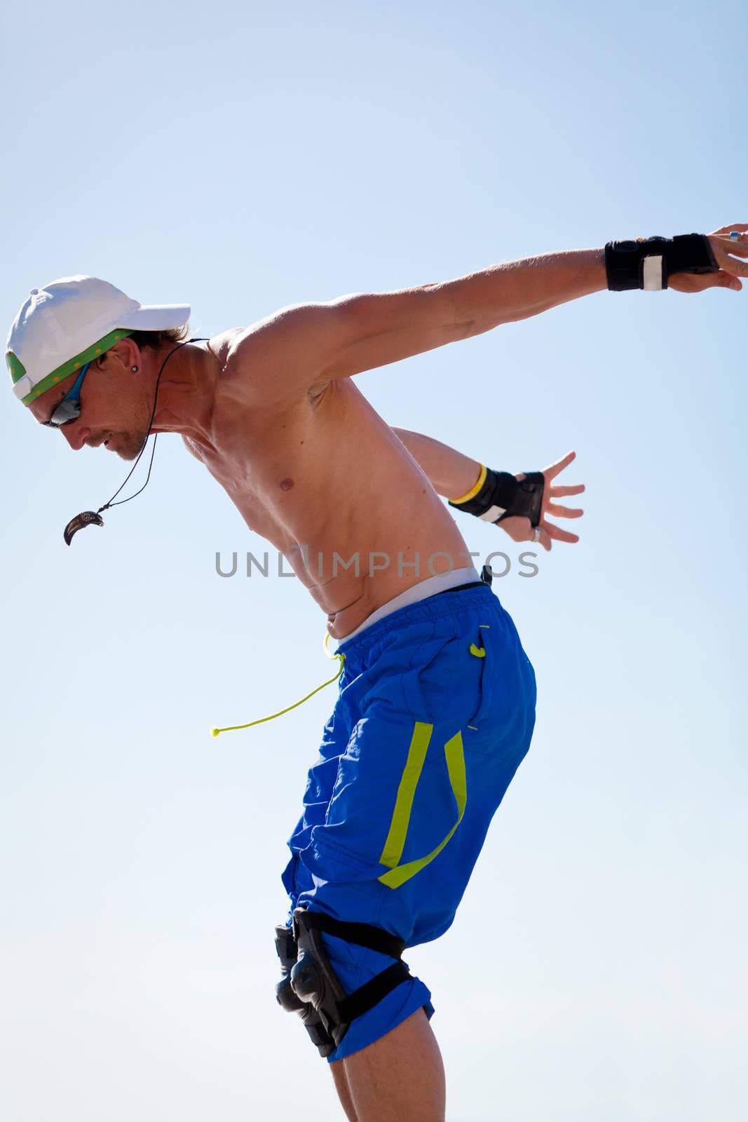 young man with inline skates in summer outdoor rollerblades skater