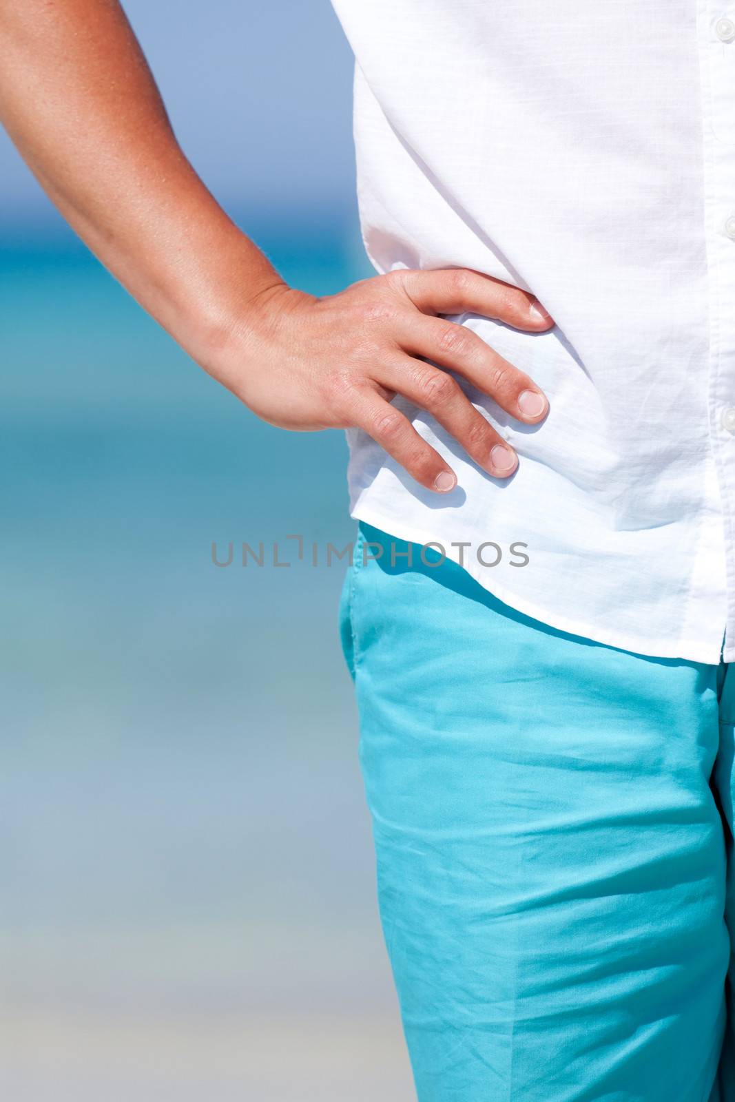 young man walking on the beach in summer holiday vacation