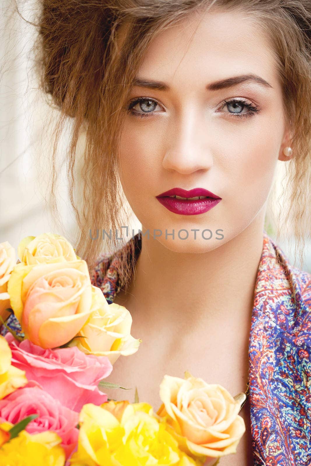 attractive young woman with pink roses outdoor on street