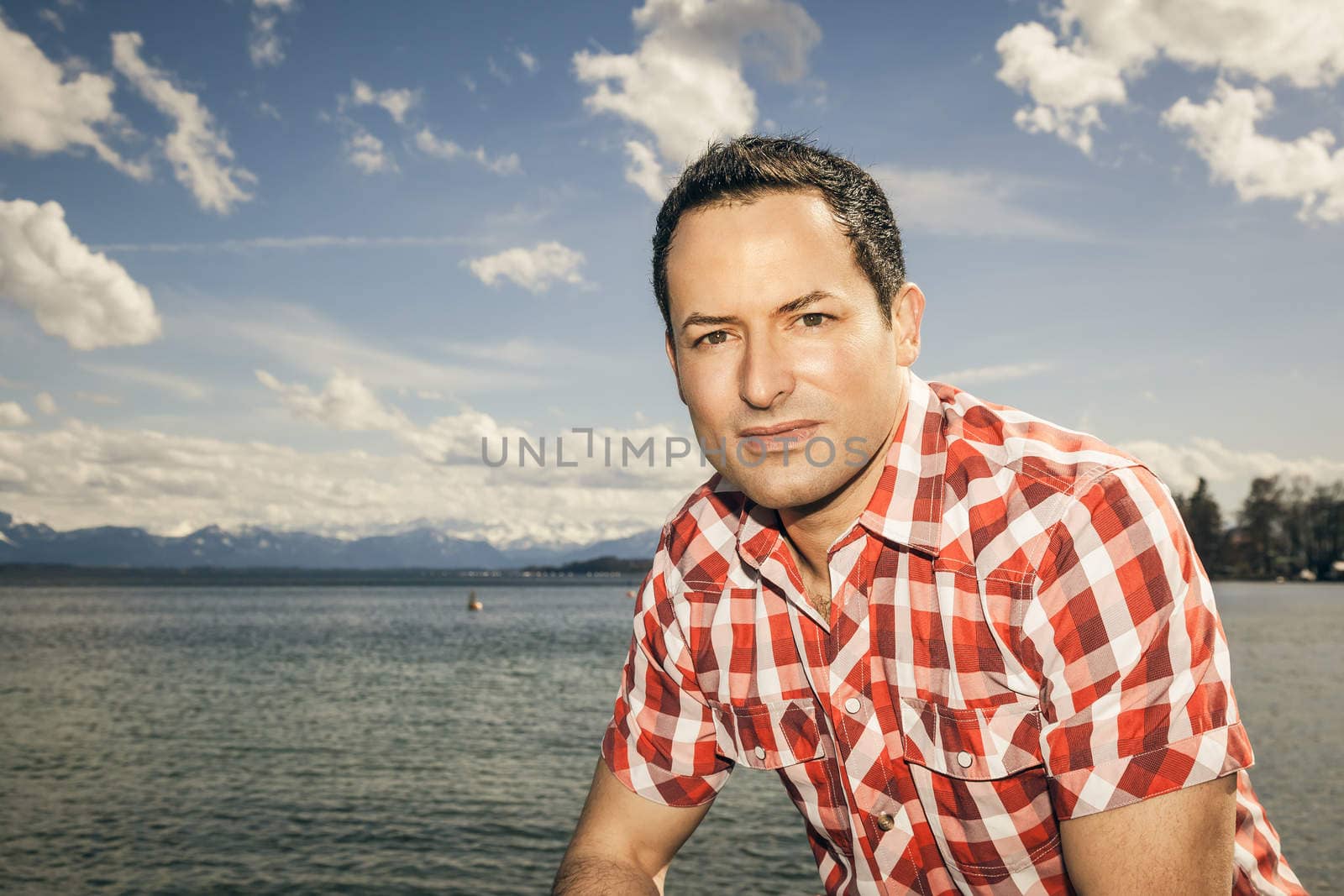 An image of a handsome man at the lake