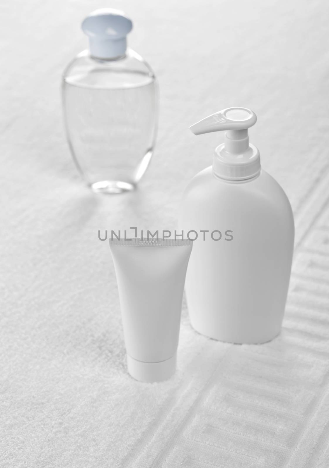 plastic bottles on white cotton towel towel