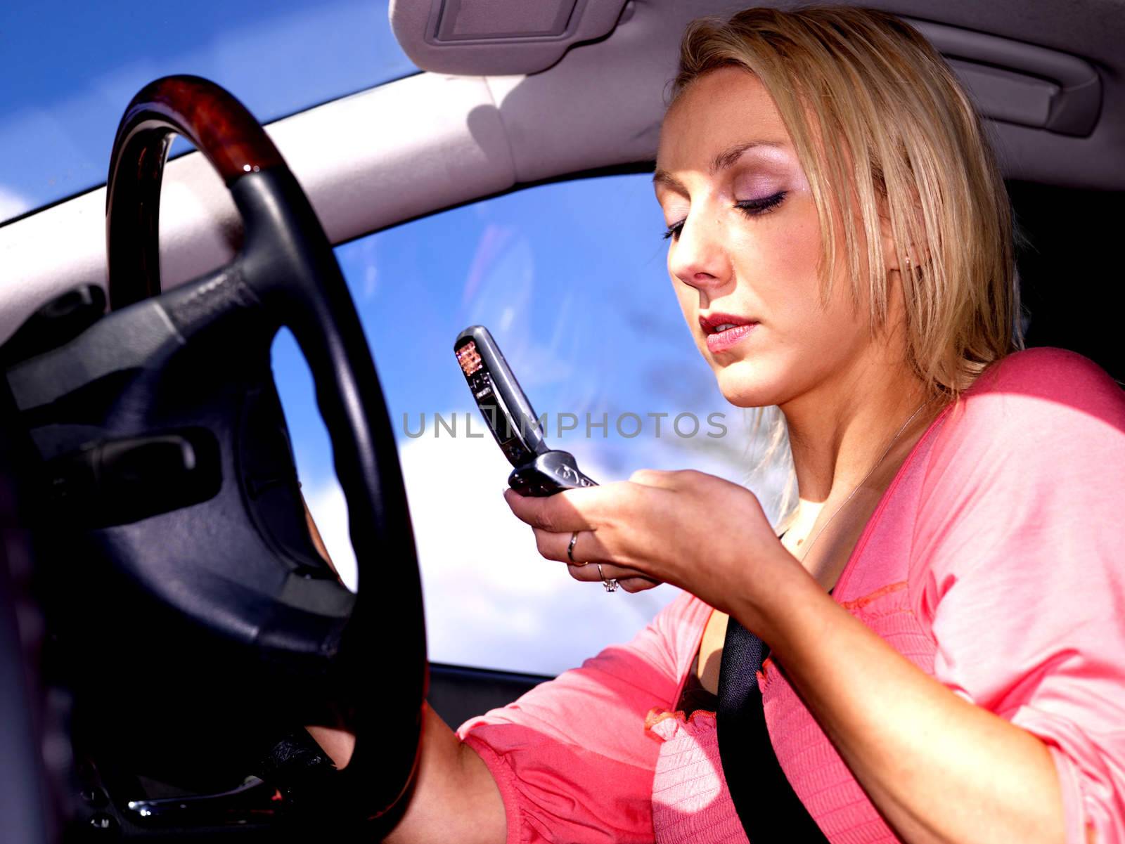 Young Woman Driving Dialing Mobile Telephone. Model Released