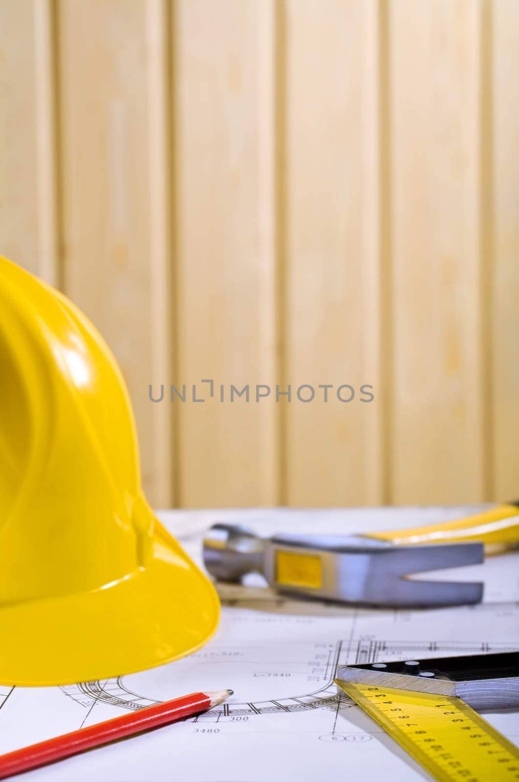 composition of helmet, pencil, angle ruller and claw hammer