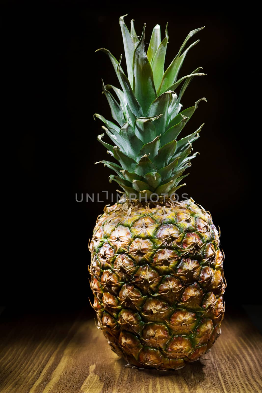 one pineapple on wooden board
