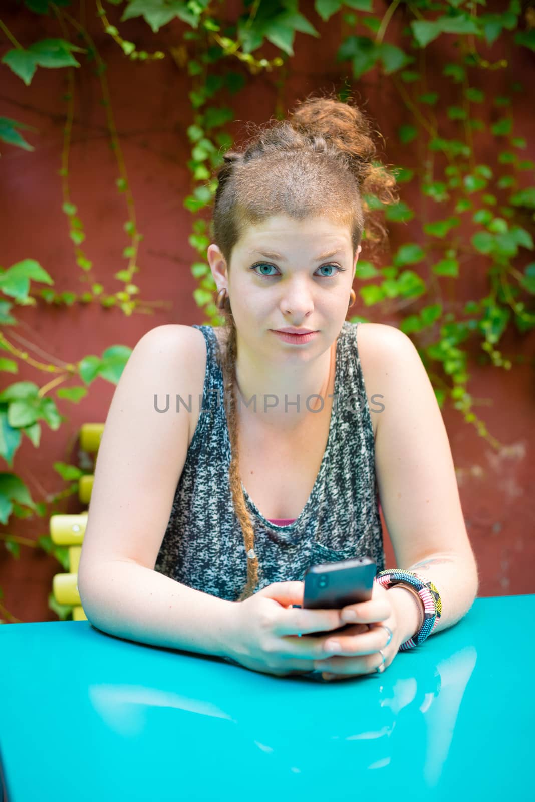 beautiful stylish modern young woman on the phone in the city