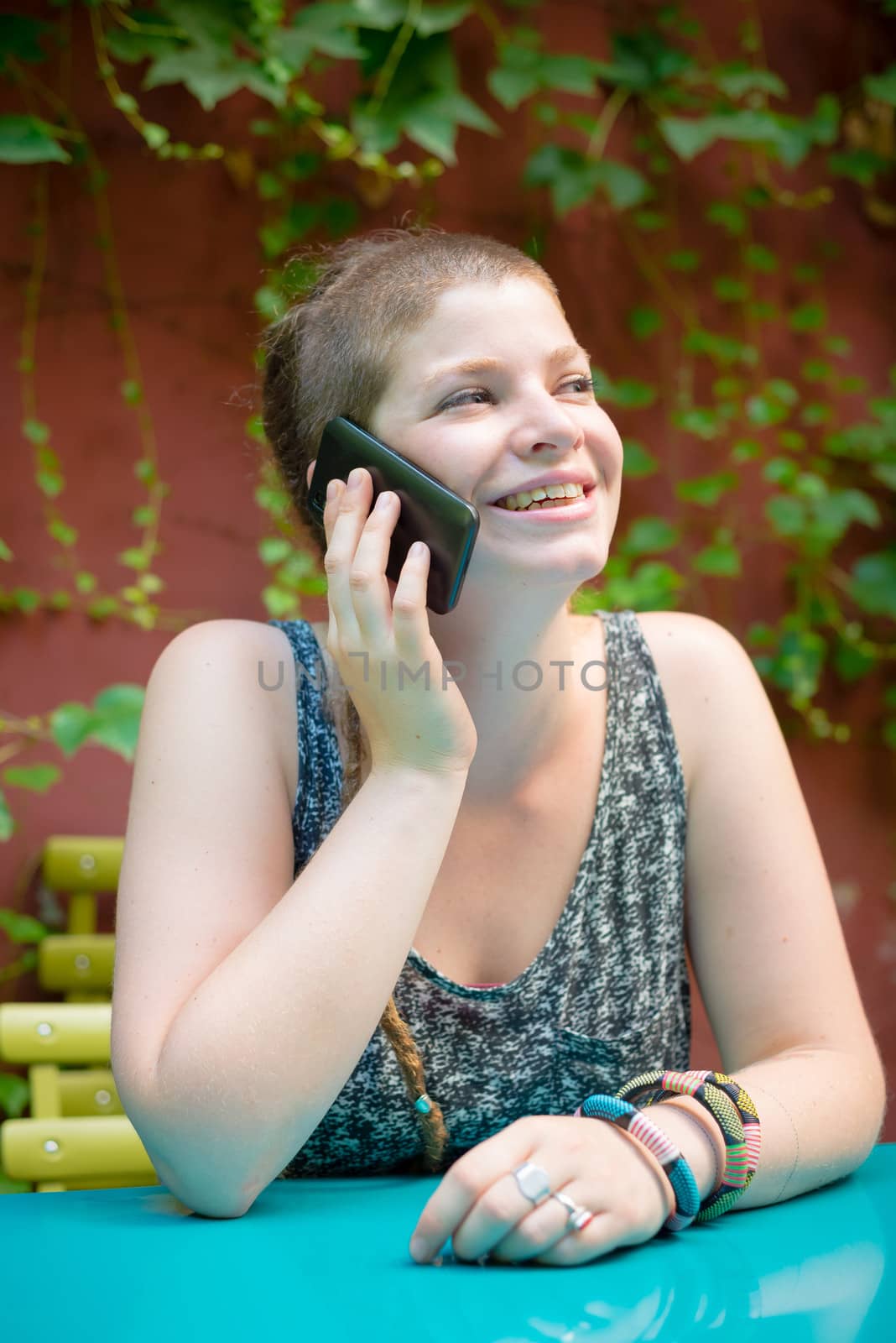 beautiful stylish modern young woman on the phone in the city