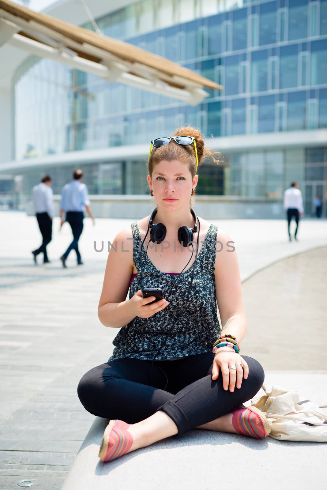 beautiful stylish modern young woman on the phone in the city