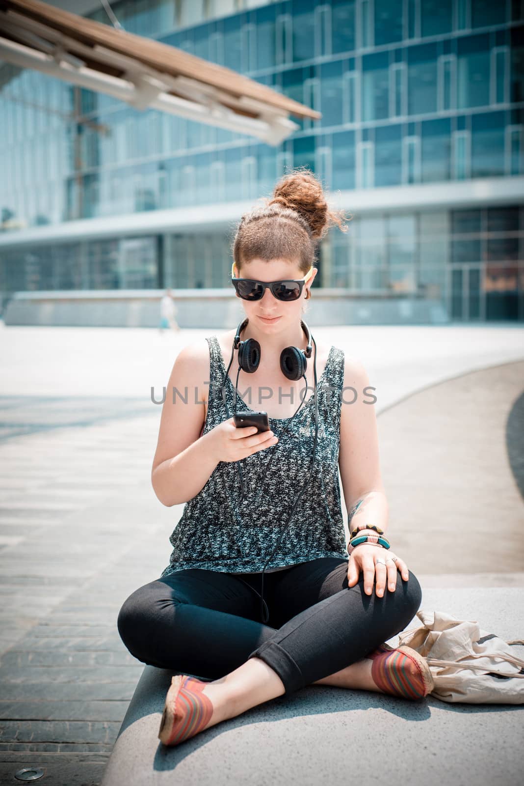 beautiful stylish modern young woman on the phone in the city