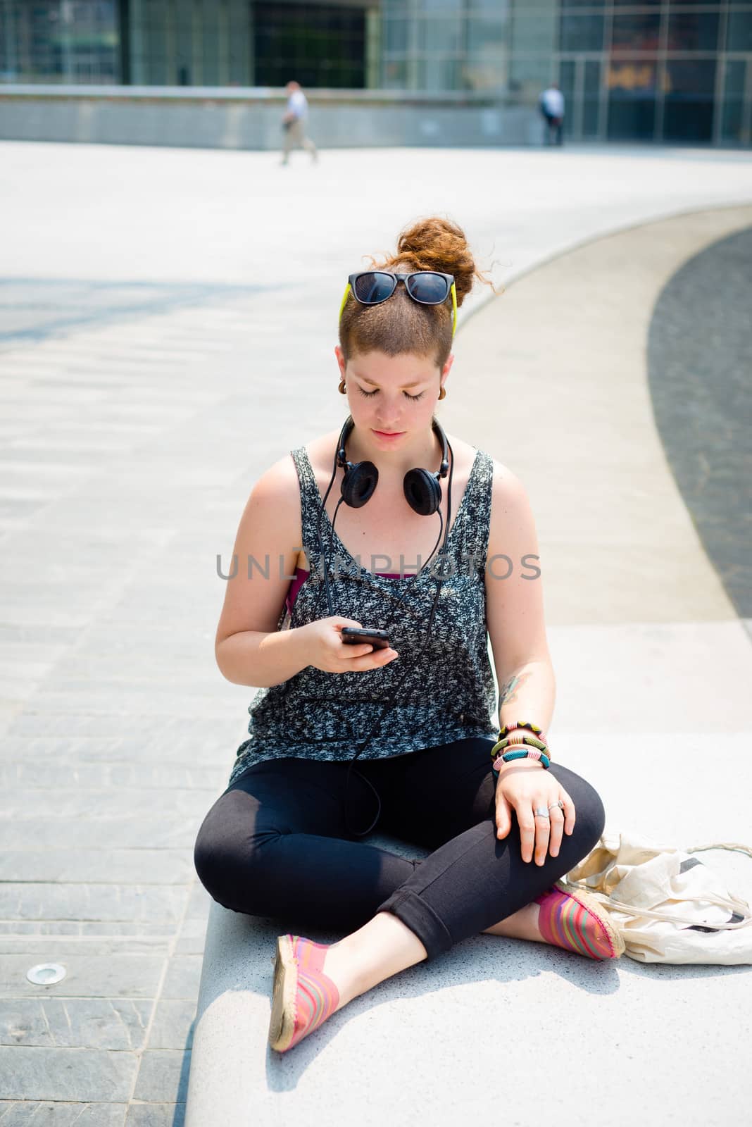 beautiful stylish modern young woman on the phone in the city