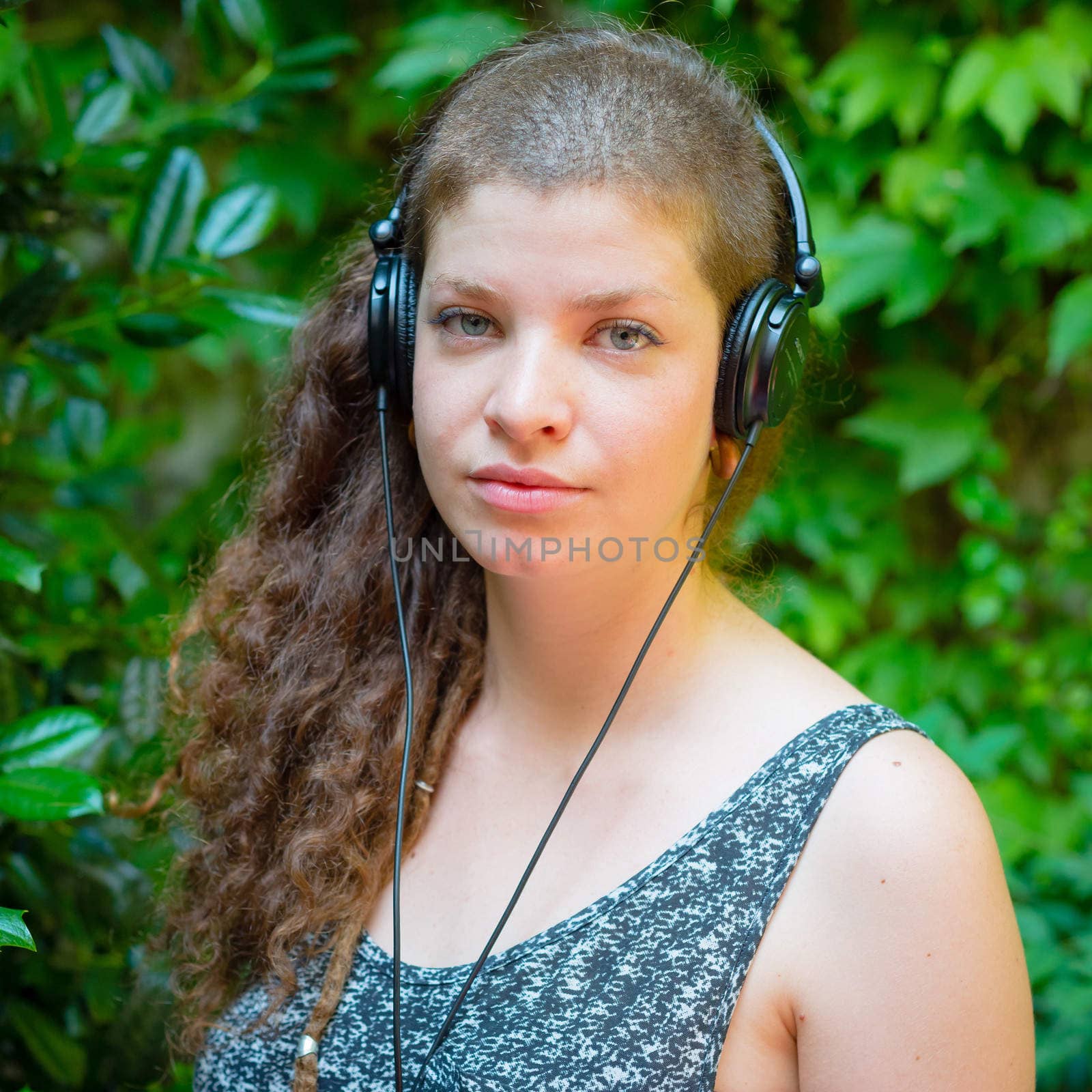 beautiful stylish modern young woman listening to music by peus