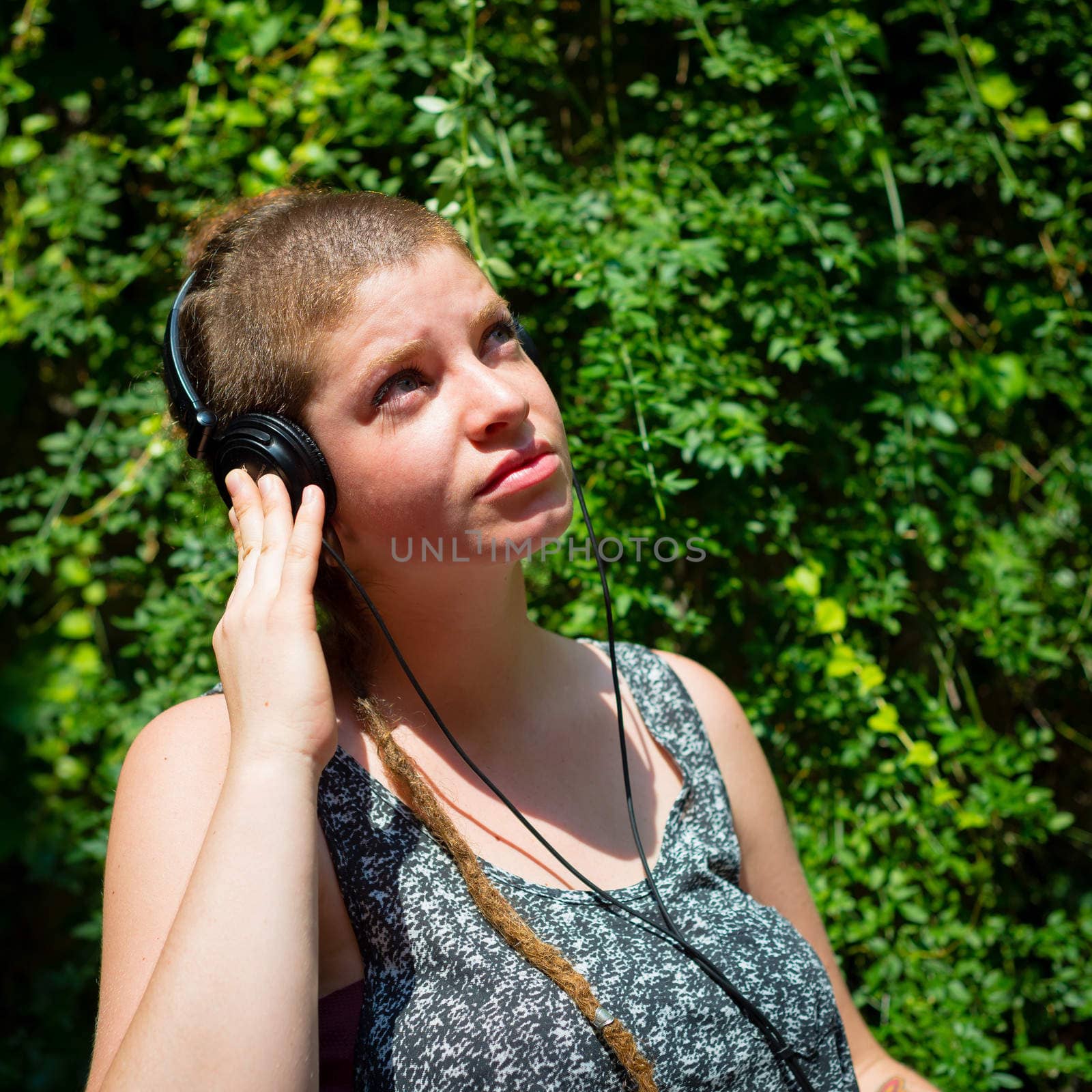 beautiful stylish modern young woman listening to music by peus