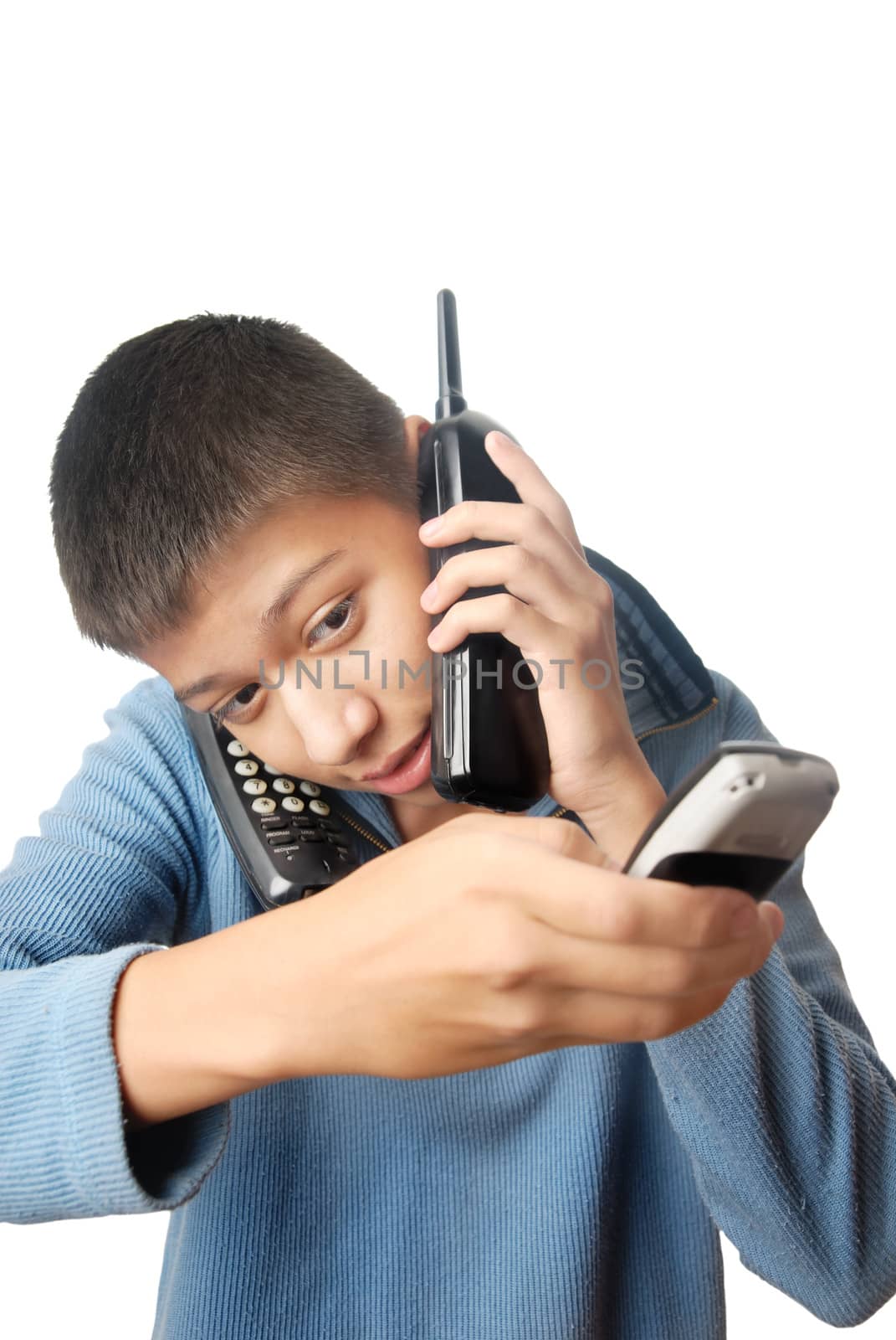 Boy having an urgent talk via three telephones