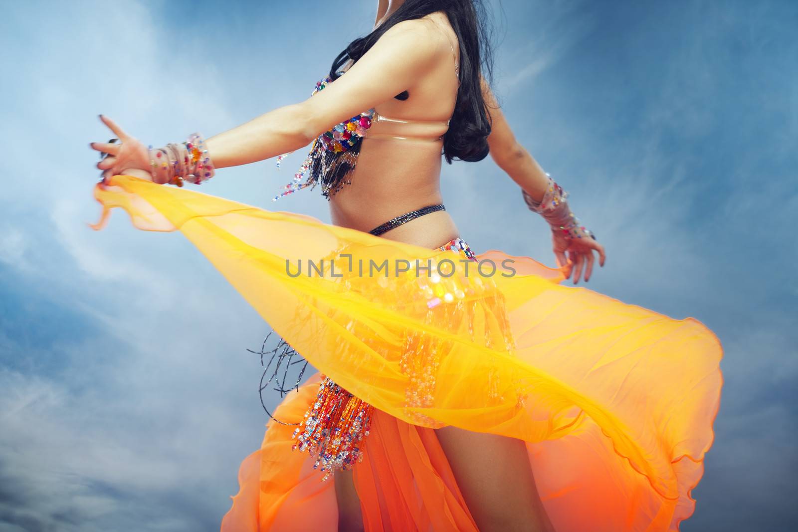 Lady dancing belly dance outdoors in summer