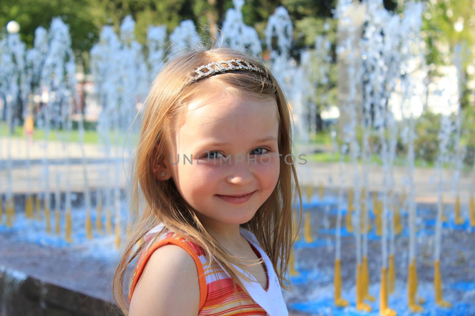 little fashionable girl on the background of fountains