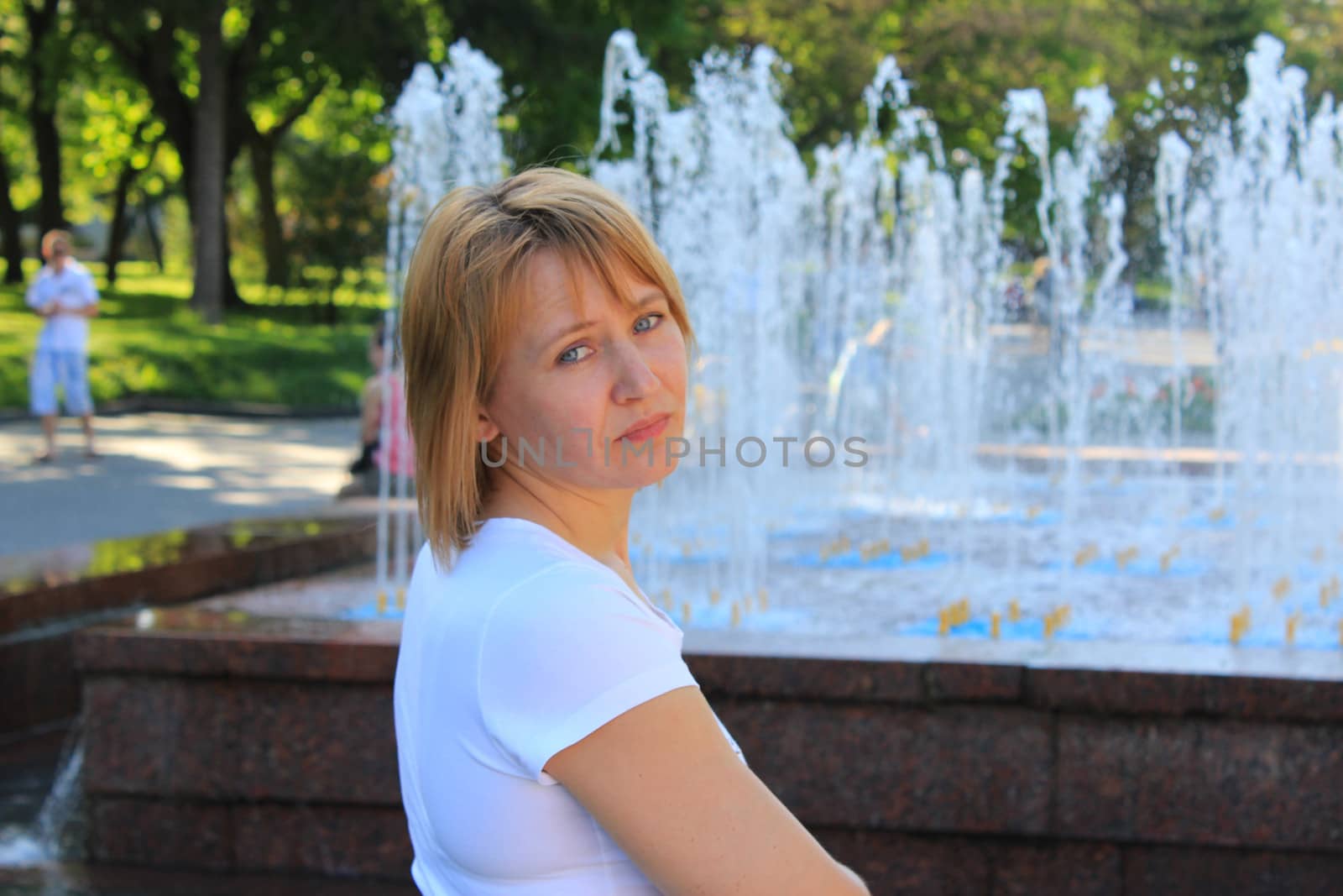 portrait of sympathetic young woman on the background of fountains